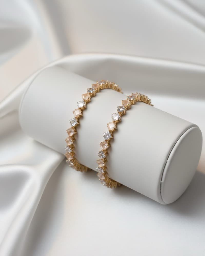 Peach & White Diamond-Shape Stone Flexible Bangle – Golden Under Finish, photographed against a plain background