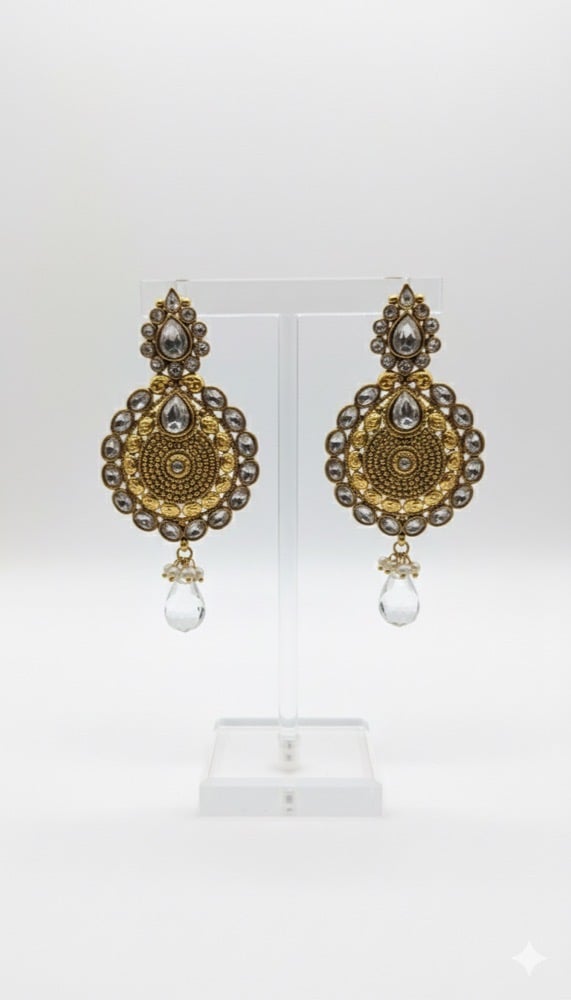 Heavy kundan gold-polish earrings on a plain background