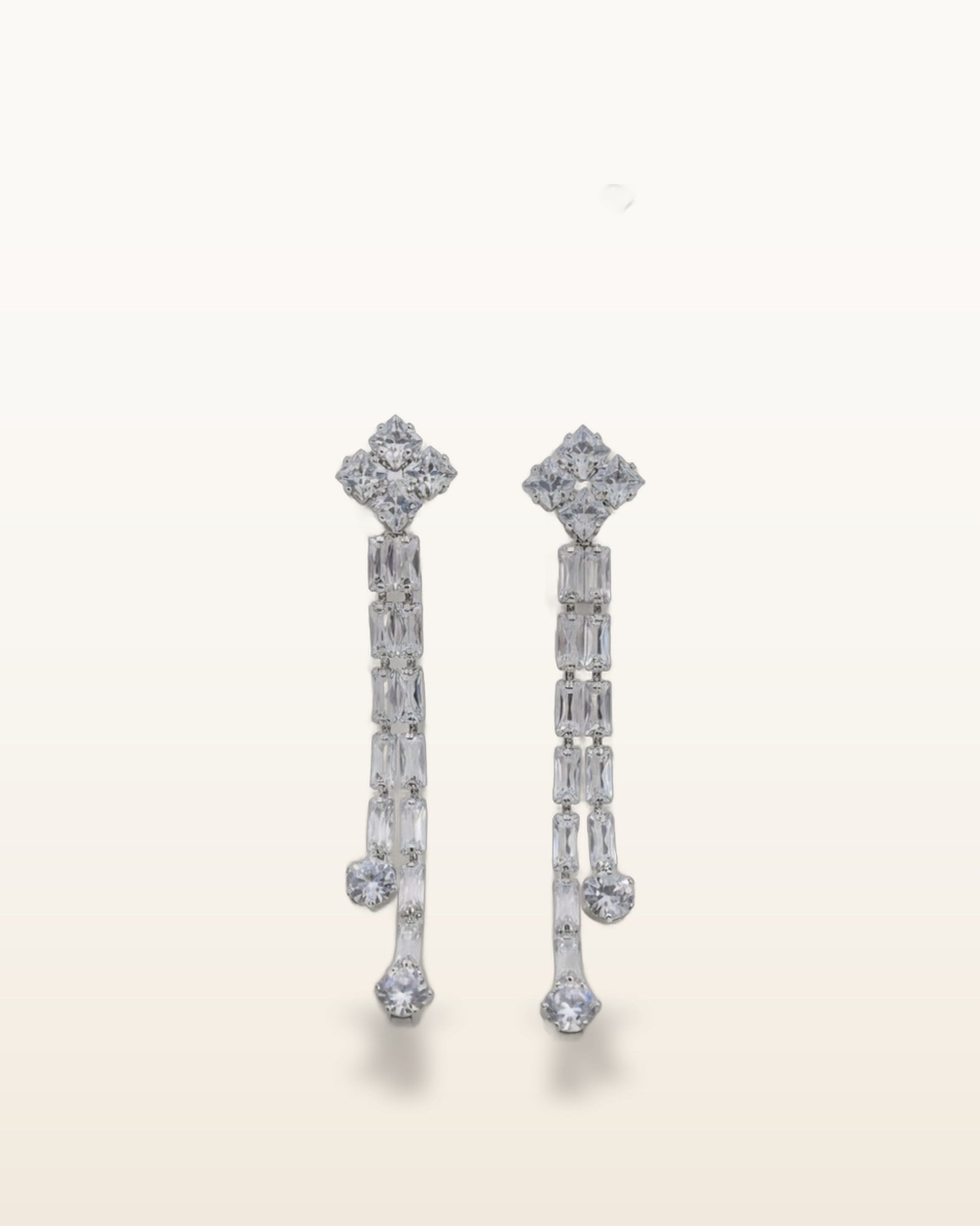 Luna zircon cascade drop earrings on warm ivory