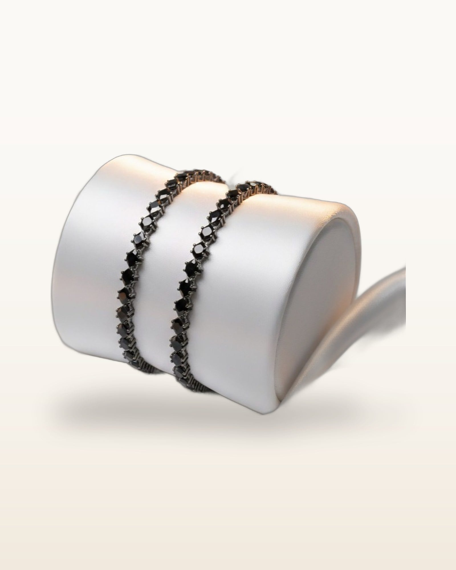 Black diamond-shape stone flexible bangle on warm ivory
