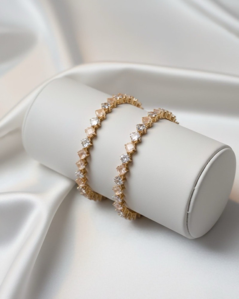 Peach & White Diamond-Shape Stone Flexible Bangle – Golden Under Finish, photographed against a plain background